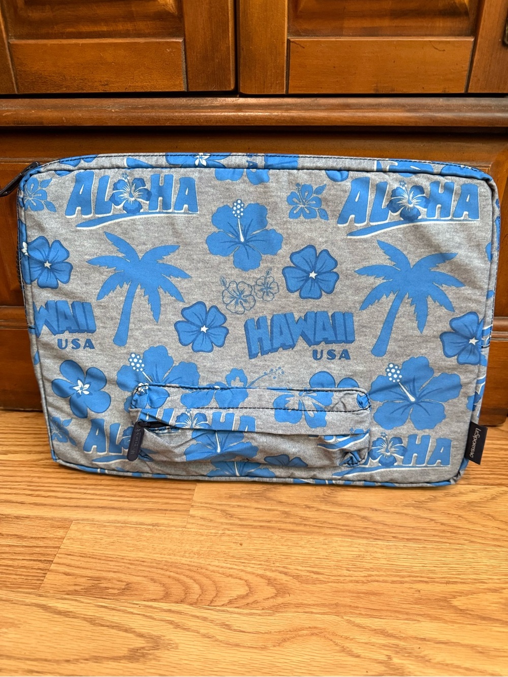 LeSportsac brand travel pouch or laptop case featuring a blue and grey hibiscus